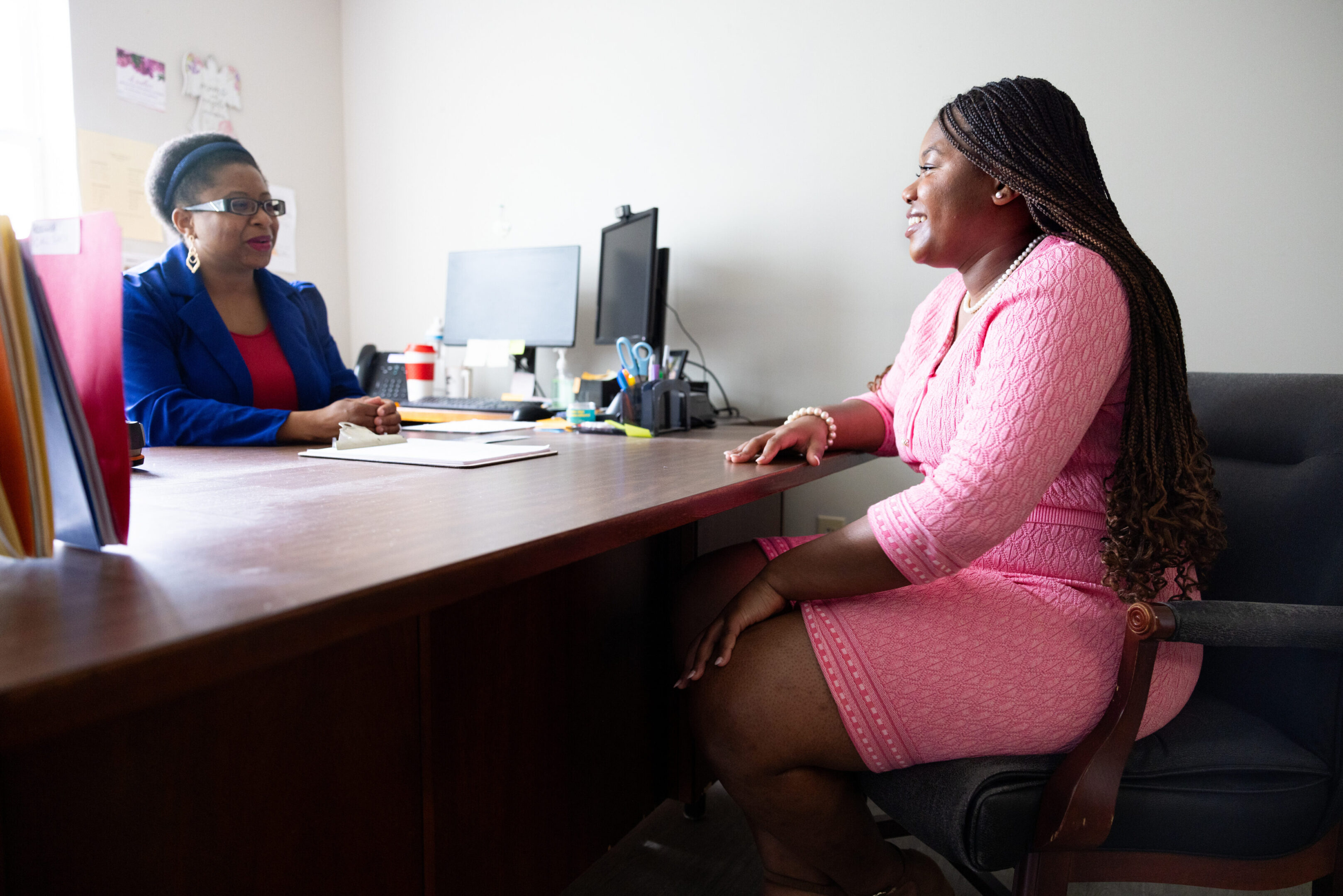 Two women engaged in a professional office meeting.